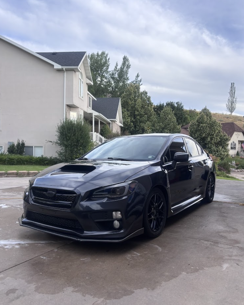 Black Subaru WRX freshly detailed in a Highland, Utah driveway