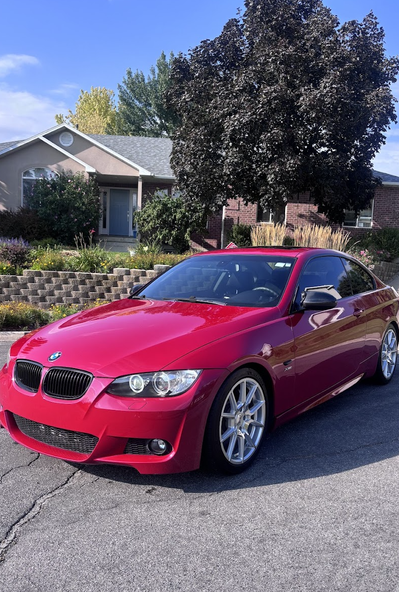 Red BMW coupe with glossy paint after an exterior detail in Utah Valley