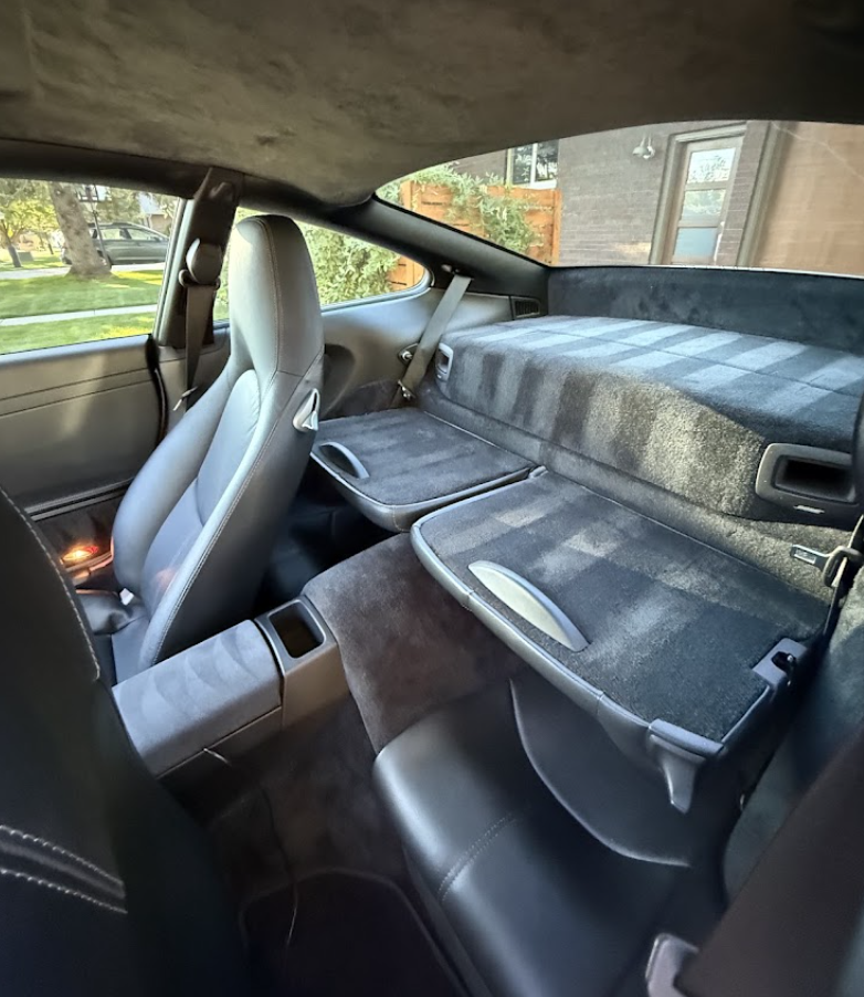 Deep-cleaned leather and suede rear seats after an interior detail